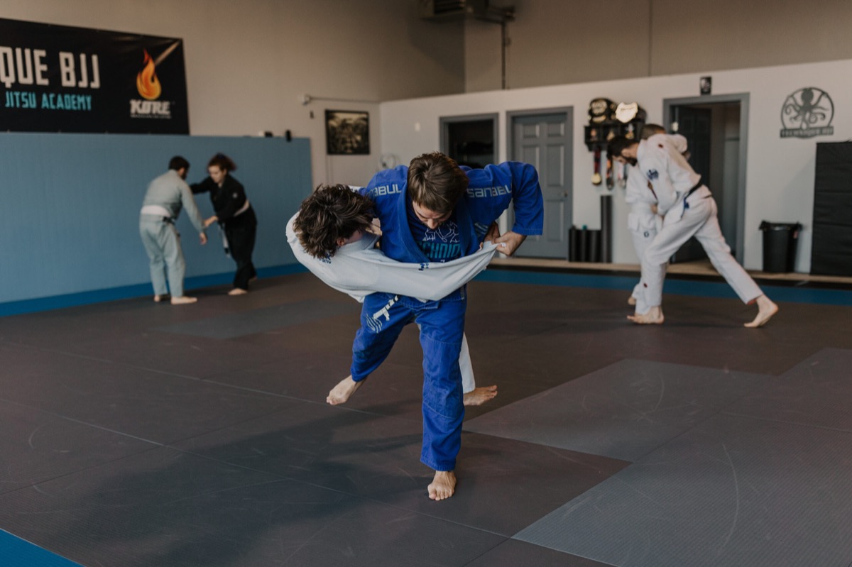 Students rolling on the mat